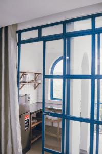an open door in a kitchen with a window at Ivy house in Hue
