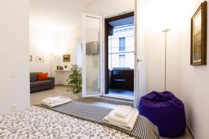 a living room with a door open to a room at Queen of Brera - San Marco 1 in Milan