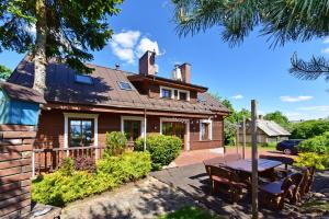 a house with a picnic table in front of it at Spa Villa Trakai in Trakai