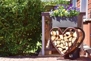 a heart sign sitting next to a pile of fire wood at Spa Villa Trakai in Trakai
