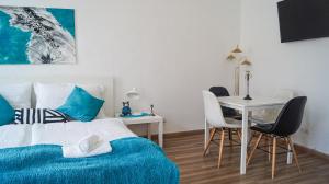 a bedroom with a bed and a table and chairs at Gorgeous 2BR - Spacious & Suitable for Everyone in Vienna