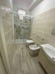 a bathroom with a shower and a toilet and a sink at Residence La Perla Marzamemi in Pachino