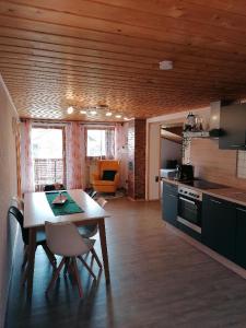 a kitchen with a table and a dining room at Ferienwohnung Weindl Lucia in Kollnburg