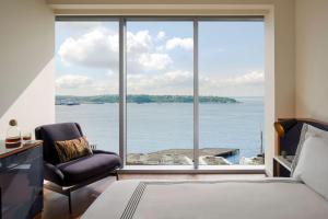 a bedroom with a large view of the water at Thompson Seattle, by Hyatt in Seattle