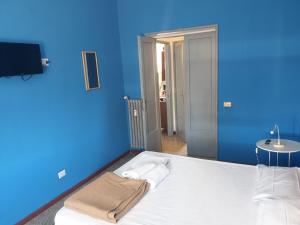 ローマにあるアート イン アコモデーションの青い壁のベッドが備わる青い部屋