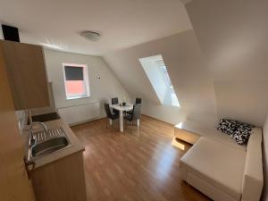 a small apartment with a kitchen and a table at TM Apartments in Straß in Steiermark