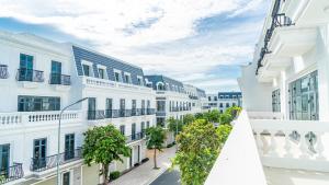 an empty street in a city with white buildings at GOLD CITY Hotel in Tây Ninh