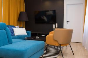 Televízia a/alebo spoločenská miestnosť v ubytovaní Apartament Kołobrzeg Quattro
