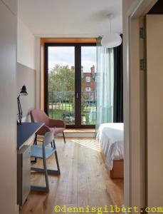 a bedroom with a desk and a bed and a window at Newnham College - University of Cambridge in Cambridge