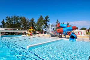 a swimming pool with a water slide in a resort at Hotel Park Plava Laguna in Poreč