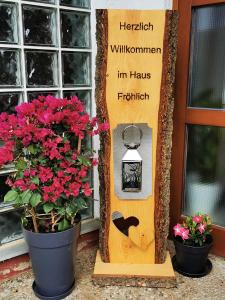 a sign with a bird and flowers in front of a door at Haus Froehlich in Michelstadt