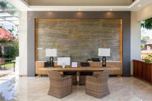 an office with a wooden table with two lamps at The Gantari Ubud Hotel & Villa in Ubud