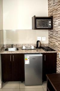 a kitchen with a sink and a counter top at Bayside Hotel & Self Catering 110 West Street in Durban