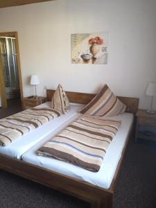 a bed in a room with two pillows on it at Gasthaus zur Krone in Feilbingert