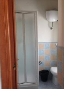 a bathroom with a toilet and a glass shower stall at Casa vacanze Mamma Rosa in Canale Monterano +10 photos