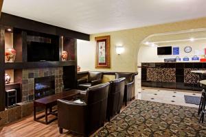 a bar with leather chairs and a fireplace at Days Inn by Wyndham Charlotte/Woodlawn Near Carowinds in Charlotte