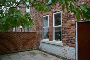 a brick building with three windows on it at Liverpool City Stays - Economy Room Close to city centre GG in Liverpool