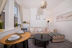 a living room with a couch and a table at Liverpool City Stays - Economy Room Close to city centre GG in Liverpool