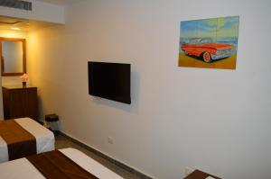 TV a/nebo společenská místnost v ubytování Royal Inn Residence