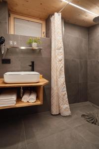 a bathroom with a sink and a shower at Spycher - Chalets für 2 in Riezlern