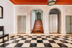 an empty room with a checkerboard floor at Chiado Prime Camões Apartment in Lisbon