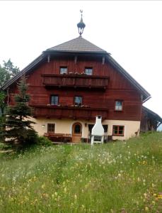a large wooden barn on top of a field at Kiblerhof in Russbach am Pass Gschütt
