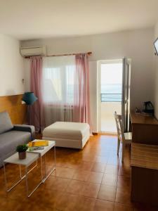 a living room with a couch and a table at Hotel Patricia in Torreguadiaro