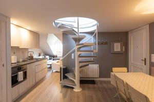 a spiral staircase in the middle of a kitchen at Telera ❅ Personalidad y matices nórdicos ❀❀ in Sallent de Gállego