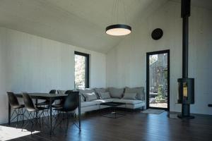 a living room with a couch and a table and chairs at MAAJO Boutique Hotel in Valgalciems
