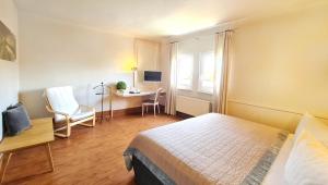 a bedroom with a bed and a desk with a computer at Häuser der Villa Italia in Marktheidenfeld +18 photos