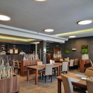 a dining room with wooden tables and chairs at Penzion Maděřič in Moravský Žižkov