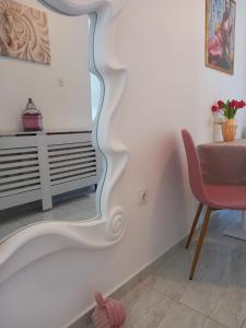 um quarto com uma mesa, uma cadeira e um espelho em Studio Apartmani “Jarnečić” em Krk