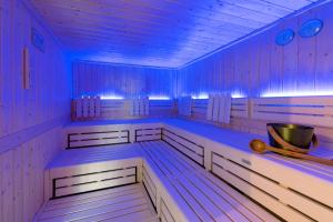 a sauna with blue lights on the inside of it at Parkhotel Hohnstein by STEIGER Hotels in Hohnstein