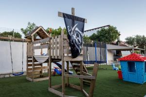 a wooden playset with a flag on top of a playground at Villa Resperi in Gonia