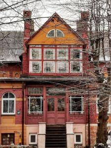 Casa con puertas rojas y ventanas blancas en LUCKY 7 apartment, en Liepāja