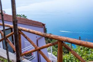 a view of the ocean from the balcony of a house at Albergo Diffuso Bacco Furore in Furore