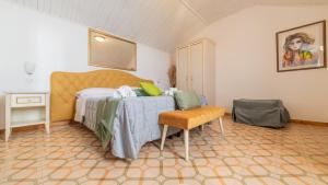 a bedroom with a bed and a chair at Albergo Diffuso Bacco Furore in Furore