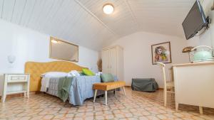 a bedroom with a bed and a tv in a room at Albergo Diffuso Bacco Furore in Furore