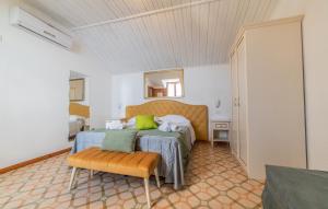 a bedroom with two beds and a chair in it at Albergo Diffuso Bacco Furore in Furore