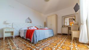 a bedroom with a bed and a table and a mirror at Albergo Diffuso Bacco Furore in Furore