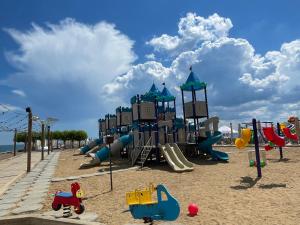 a playground in the sand on a beach at Apartment Riviera in Fontanka