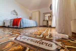 a bedroom with a bed and a tiled floor at Albergo Diffuso Bacco Furore in Furore