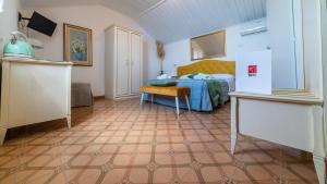 a bedroom with a bed and a table in a room at Albergo Diffuso Bacco Furore in Furore