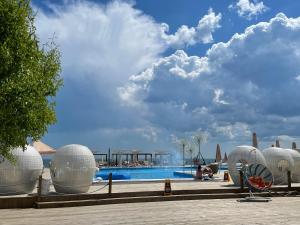a pool at a resort with white spheres around it at Apartment Riviera in Fontanka