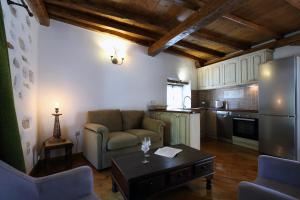 a living room with a couch and a table at Stafilos House in Katouna