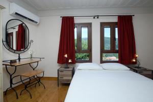 A bed or beds in a room at Stafilos House