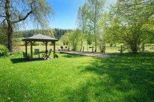a park with a gazebo in the grass at Le Clos Arboré (Gîte) in Libramont