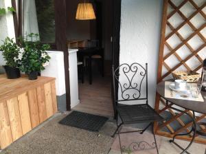 a black chair sitting in front of a door at Oberholzer Landhaus & Appartement in Ellmau