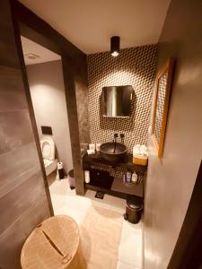 a bathroom with a sink and a toilet at Corfu port apartment in Mantoúkion