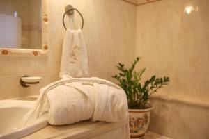a bathroom with a white tub and a towel at VILA KALIELAIA in Mouzákion +45 photos